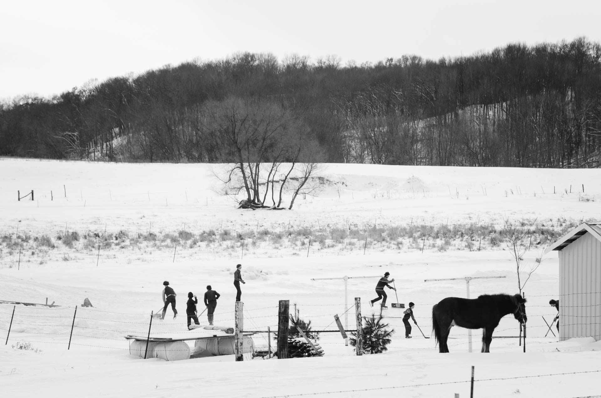 amish-kids-playing-pond-hockey-winter-augusta-wi